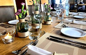 Place setting with hand made rope napkin rings and decorated vases by Emma. Photo James Fairbairns