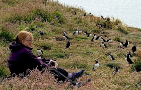 Guest surrounded by puffins Treshnish Isles Cruise Chris Gomersall